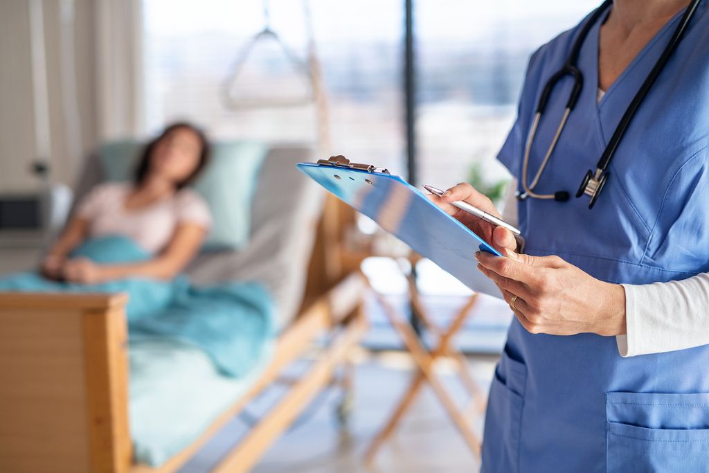 A photo of a doctor or nurse standing in hospital room, holding a clipboard. A concept of medical detox for buprenorphine dependence