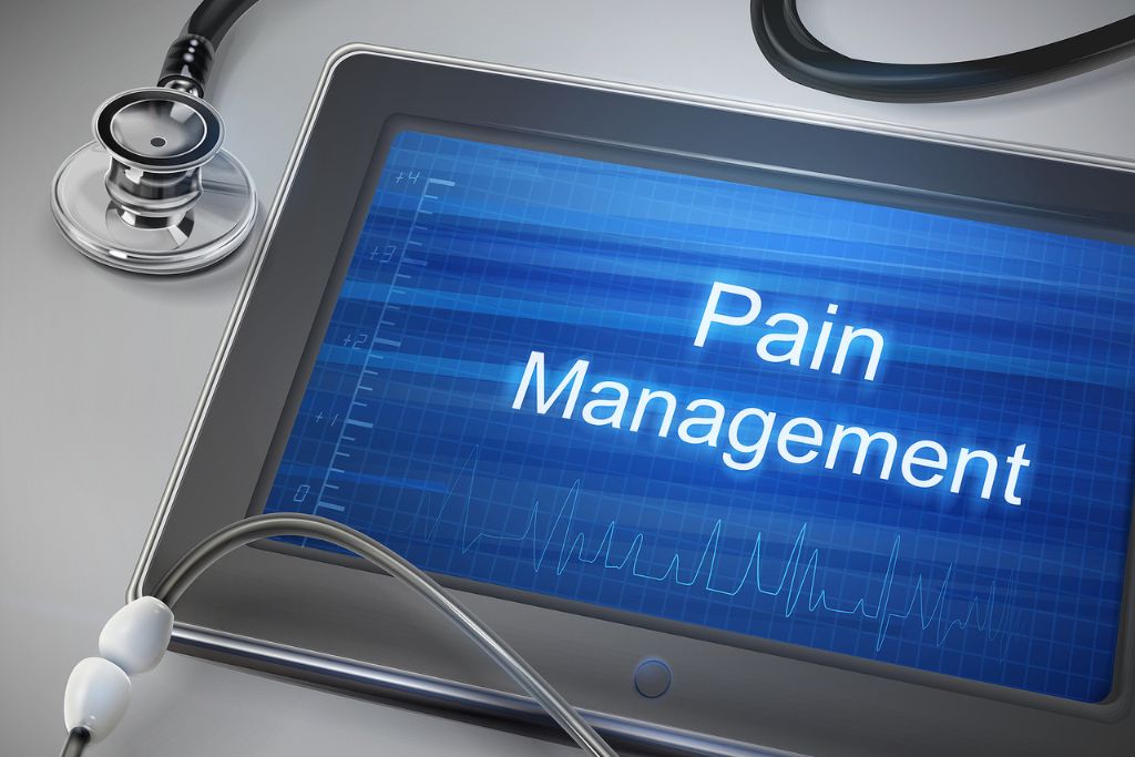 A photo with pain management words displayed on tablet with stethoscope over table, concept of comprehensive guide to pain management