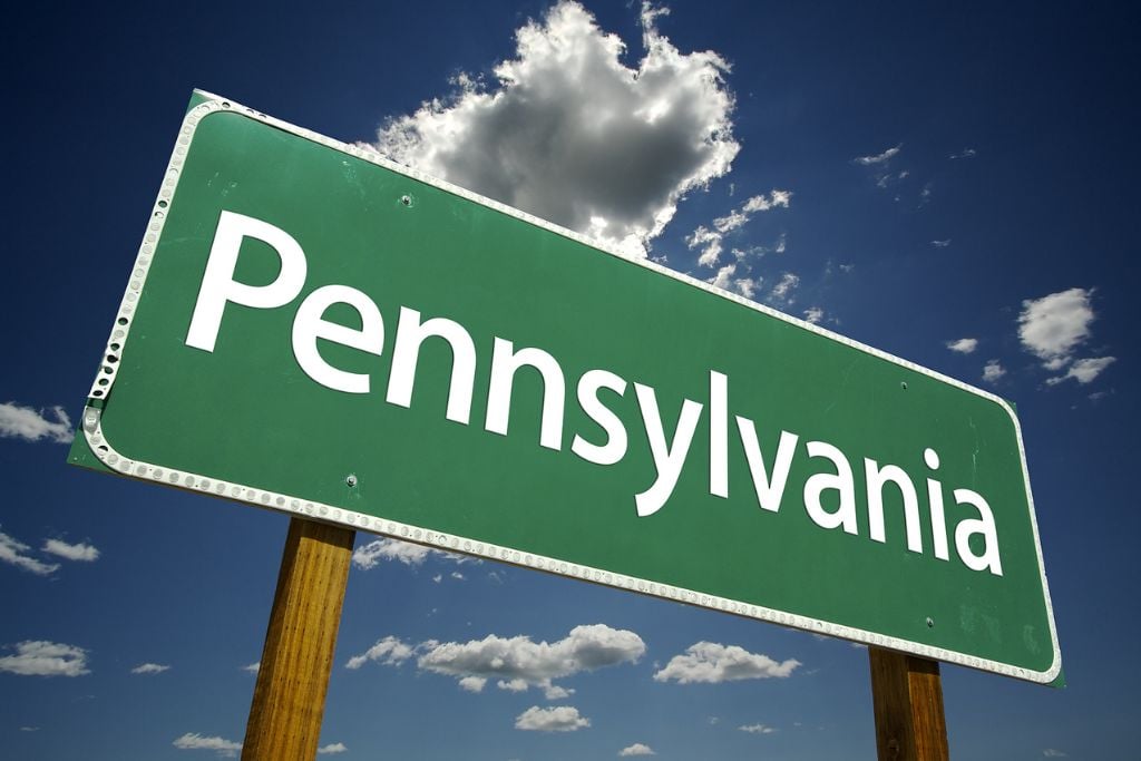 Pennsylvania Road Sign with dramatic clouds and sky. Concept of rapid detox in Pennsylvania.