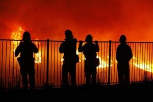 Firefighters watch a wildfire in Southern California