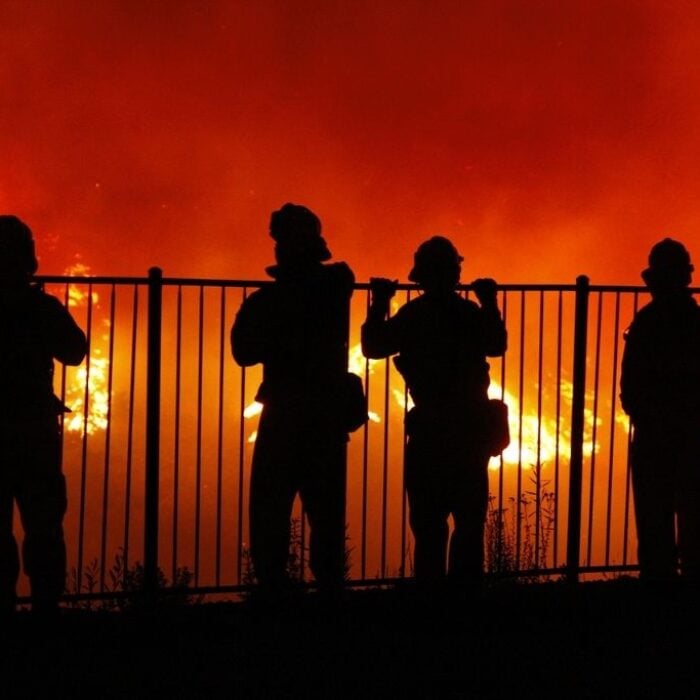 Firefighters watch a wildfire in Southern California